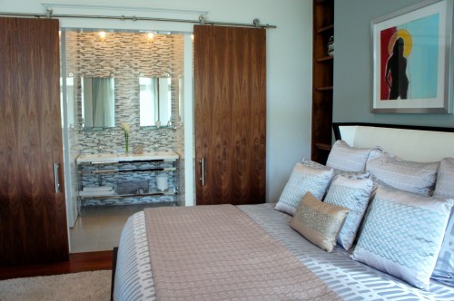 Solid wood sliding barn doors separate the bedroom and bath.
