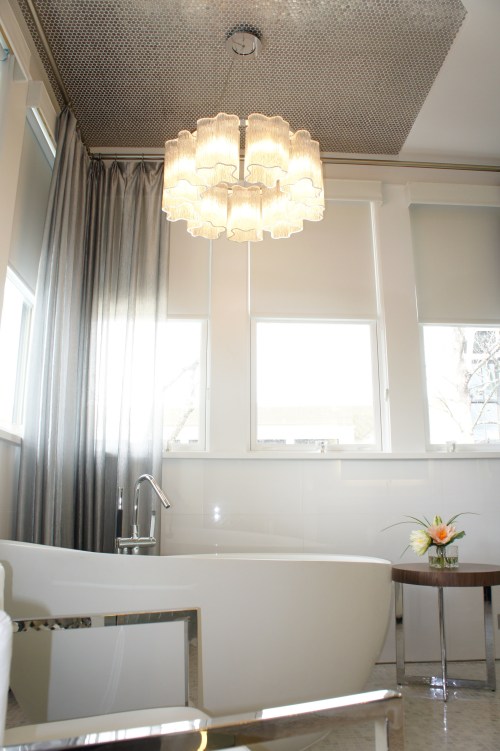 Here you can see a glimpse of the stainless penny round tile we placed on the ceiling above the tub.  They twinkle against the chandelier, and help define the space, making it more intimate.  The silver-thread sheers do this, as well, while adding an ethereal quality.