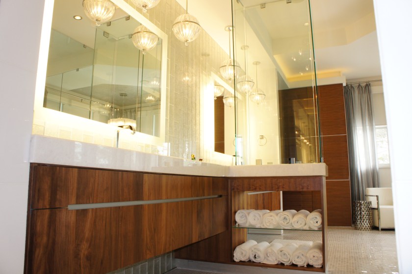 We designed the cabinets so that there would be no hardware, just a stainless reveal with hidden recesses above and below to open drawers.