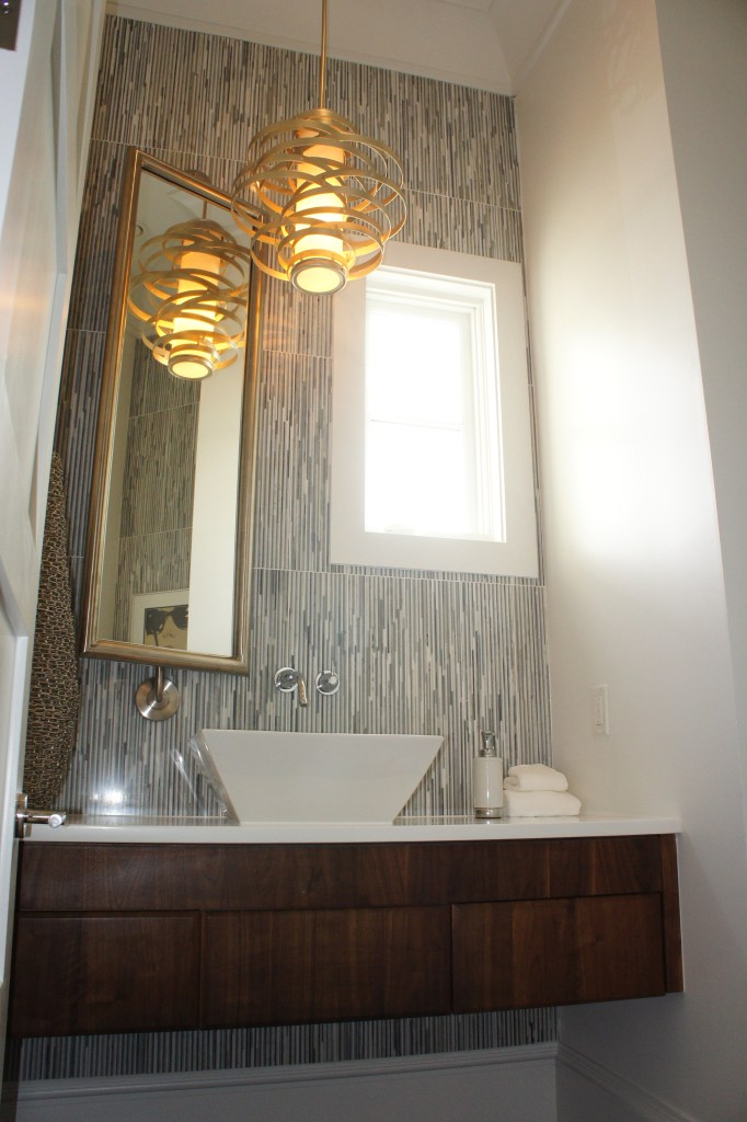 This is the bathroom and accesses the Theater Room.  I designed this custom mirror to balance the offset window, and to rotate for flexible viewing.  