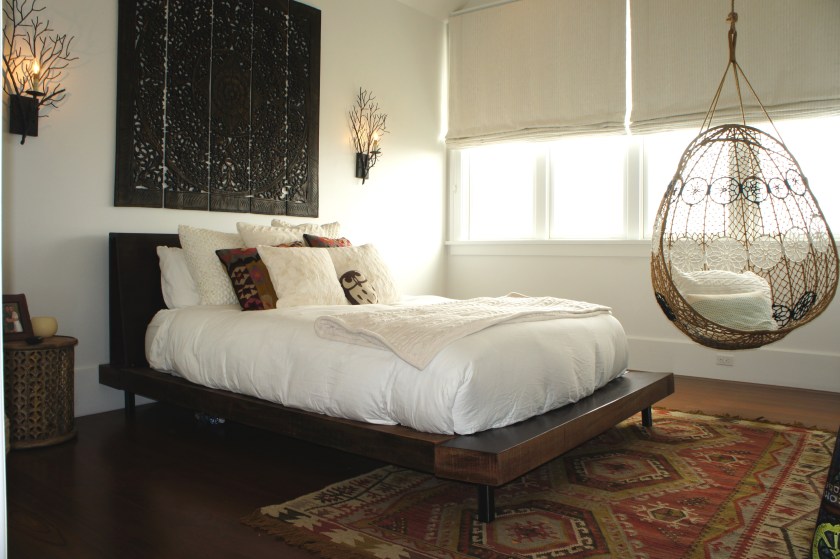 This room belongs to the daughter who preferred a "bohemian beach" décor.  The twig sconces, reclaimed wood platform bed, and wicker hanging egg chair embodied this look.  