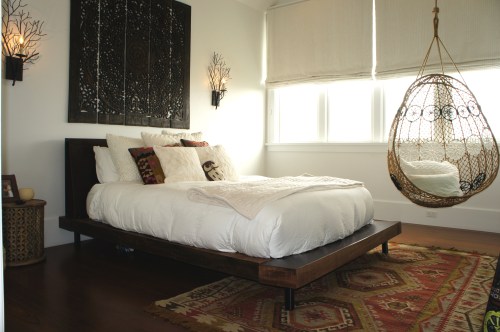 This room belongs to the daughter who preferred a "bohemian beach" décor.  The twig sconces, reclaimed wood platform bed, and wicker hanging egg chair embodied this look.  
