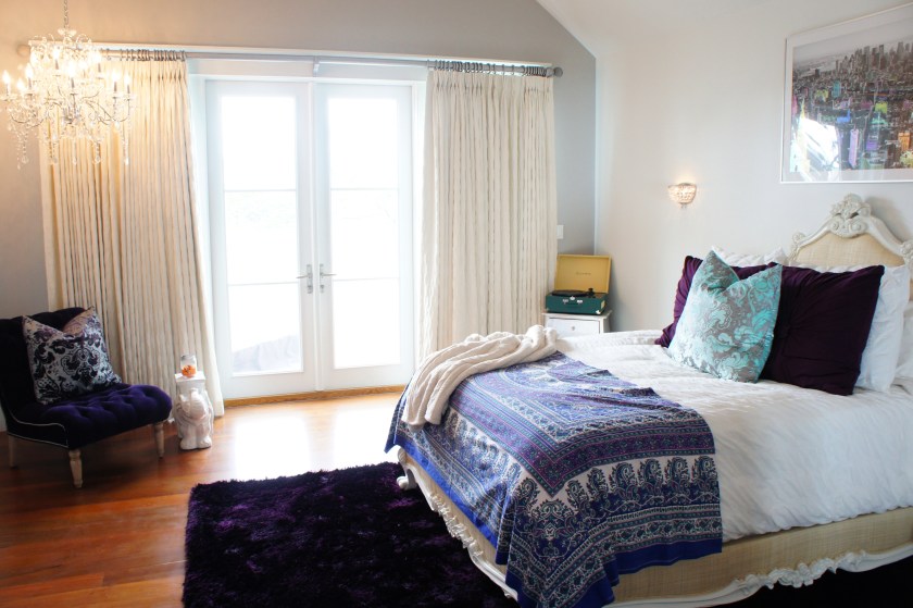 This is one of the daughters' rooms on the third floor.  This one's taste was that of high glamour, but grounded enough for the beach!  The bed from Oly emphasized just this, with its intricately carved frame and raffia upholstery. The crystal chandelier in the corner created some drama.
