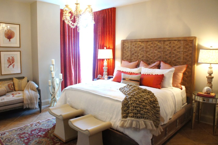 This room is calm and natural, with warm glowing pops of coral.