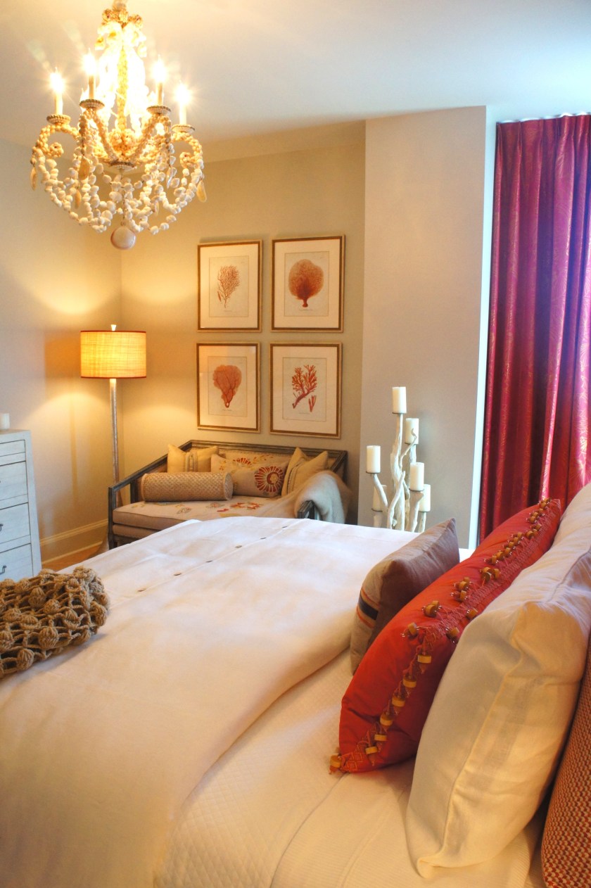 In the corner, we created a cozy nook with a plush settee underneath a set of four framed hand-colored prints.  The shell chandelier by Currey Company adds a beautiful touch of coastal.  