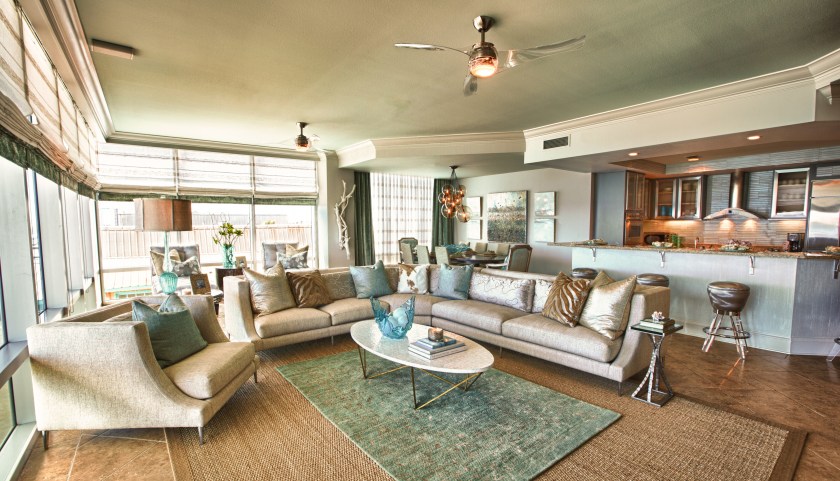 This large sectional provided some sophisticated and inviting seating to this large living area.  We layered a plush blue wool area rug on top of a large woven jute.  The oval white-shell top cocktail table by Oly was the perfect size and shape for the arrangement. 