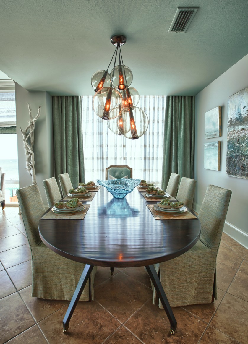 The side chairs are slipcovered in a green textured linen, and the host chairs are upholstered in a fresh pale aqua leather! The drapes and sheers give this area intimacy and drama!