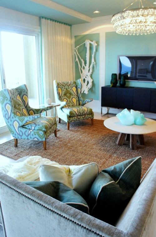 I accented all the heavier upholstery with these two contemporary wing chairs.  I absolutely love these chairs!  They are so comfortable, too!  I chose a colorful Ikat print that pulls together the blue, green and yellow I've used throughout the unit. You can also see here what a great vantage point a person lounging on the chaise lounge will have, with a view of the beach, the television, the goings-on in the kitchen, and the other living room seating.