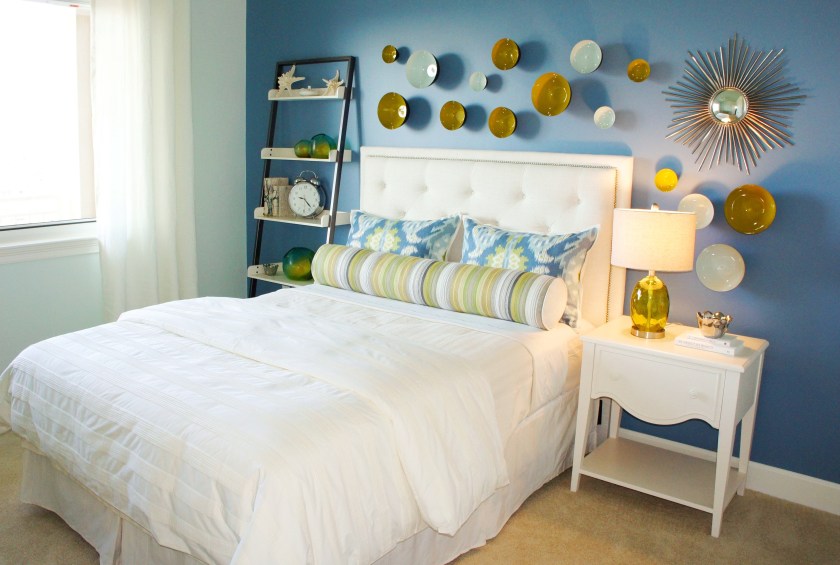 I painted these walls a pale aqua color, then gave the bed wall a dramatic "punch" of blue that contrasts well with the bed and wall décor.  
