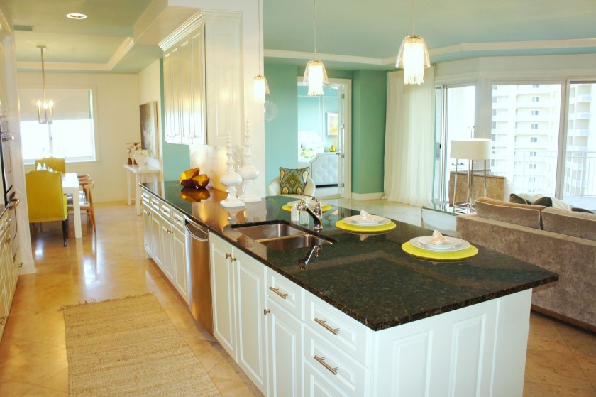 Painting the cabinets a pale ice blue brightened the kitchen and created pleasing contrast with the black granite countertops.  I replaced all the bronze knobs with stainless contemporary knobs and pulls for a fresher look.