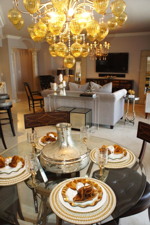 I furnished the dining area with an industrial pedestal table by Drexel Heritage, then added some side chairs with wood inlay.  The large, gold Murano glass chandelier added some drama that helped provide weight to this area.