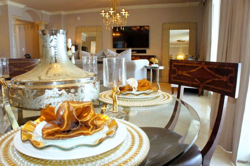 This table top is all set up for elegant entertaining, with its gold and white "bling."  The pearl and stud chargers anchor the white Waterford dinner plates and gold-rimmed ruffle Annie Glass dessert plates.  In the center, the mercury glass Moroccan vase is just waiting for some fresh flowers!