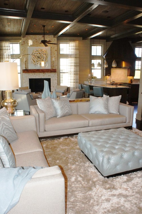 The reflective shag rug provides a plush base for the clean-lined furnishings and ice blue vinyl ottoman.  