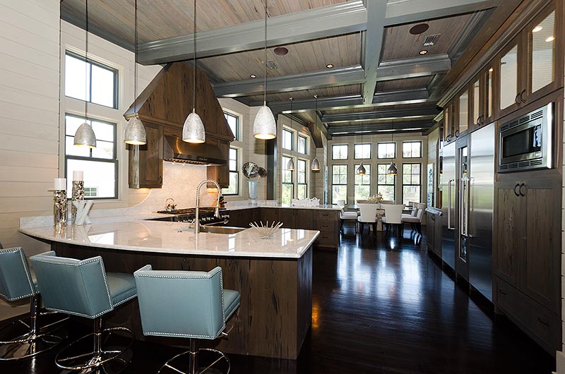 I used some contemporary Vanguard counter stools, covered in a blue vinyl, to bring some color to the kitchen area.