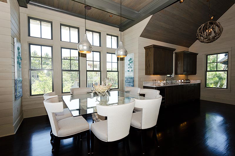 I decided that the shape of the room called for a square Dining table. It seemed to fit the space nicely. I counteracted all the square shapes and straight lines with some curvilinear klismos chairs, covered in an off-white linen, with white raffia outbacks.