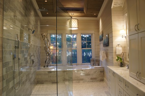 This is a stunning bathroom, with its marble floors and walls, the large open windows and recessed ceiling detail.