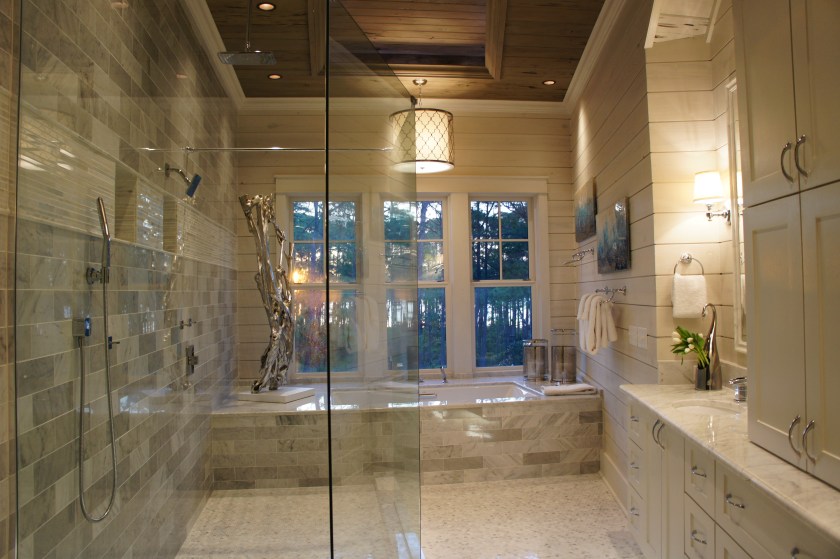 This is a stunning bathroom, with its marble floors and walls, the large open windows and recessed ceiling detail.