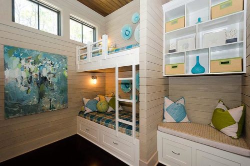 I brought some color and life to this room with custom bedding and vibrant art.  I fell in love with the plaid fabric first, made coverlets, then designed the other fabrics around that.  