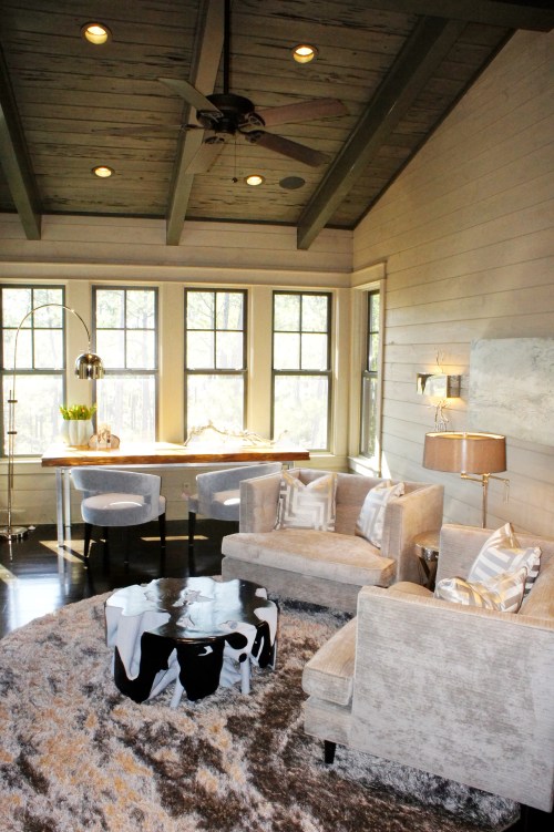 I furnished the main part of this room with a pair of gray chenille chair-and-a-halfs, and round, reflective shag rug and a unique root cocktail table. 