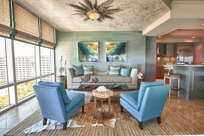 Inviting layers of texture help to define this space as the "Lounge".  Grasscloth and linen bring a natural element, while a plush area rug, layered with a cowhide add softness.  The dropped ceiling was texturized with a venetian plaster, which resembled shiny concrete. 