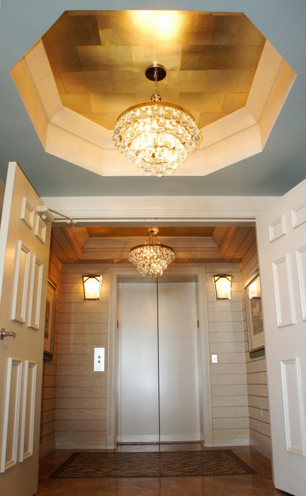 Speaking of the entry, take a look at this fabulous wallcovering technique!  The walls are covered in a striped Romo mica wallpaper.  The ceilings are covered in an iridescent gold leaf block paper!