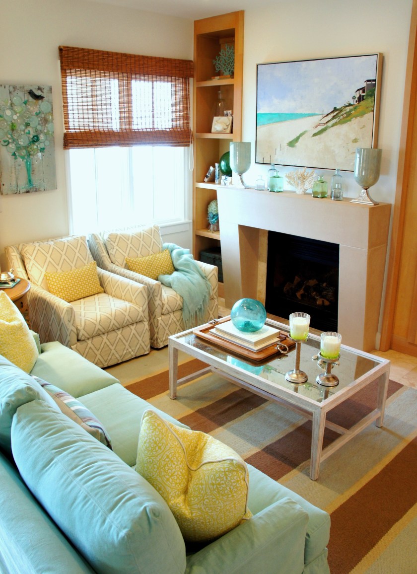 want an easy way to accessorize your coastal fireplace mantel? Find a variety of colored bud vases, some candles (in this case I used some glass hurricanes), and a great piece of coral! When the client's came to see their design for the first time, I had some bright yellow fresh flowers in each vase!