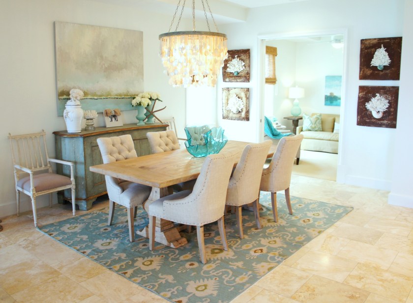 This chandelier by Made Goods was the only jewel we were able to keep from the previous design! I found this beautiful trestle table at Beau Home Interiors, and the buffet from Lovelace Interiors! The seascape art is an original painting I found across the street at Design Avenue, and the four antique ceiling tiles, with shell/coral motifs are made by local artist, Lisa Dubreuil!