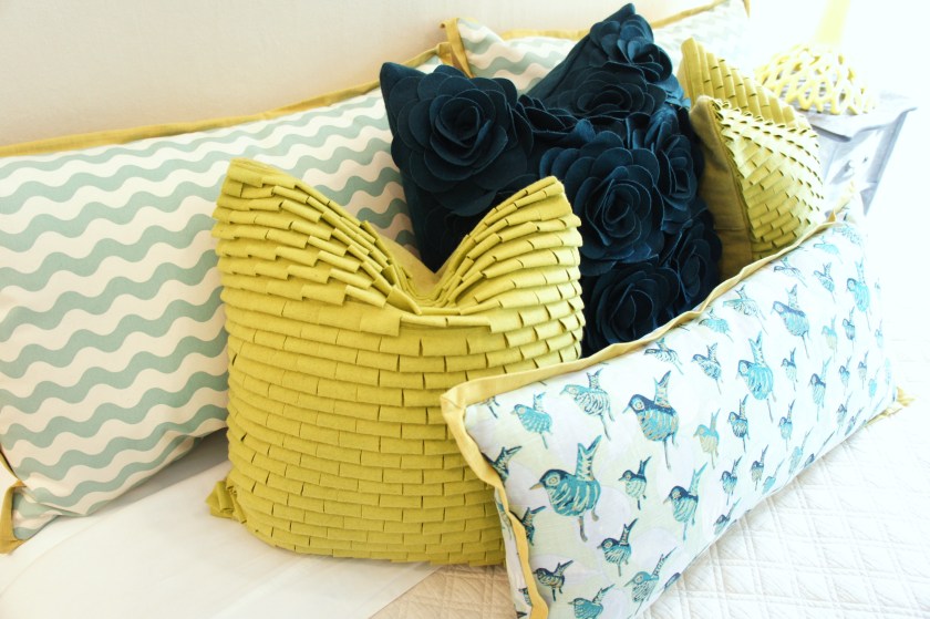 The bird print and the waves fabrics are by Lulu DK; the felt applique pillows are by Surya. Cute eclectic mix of colors, textures and pattern!