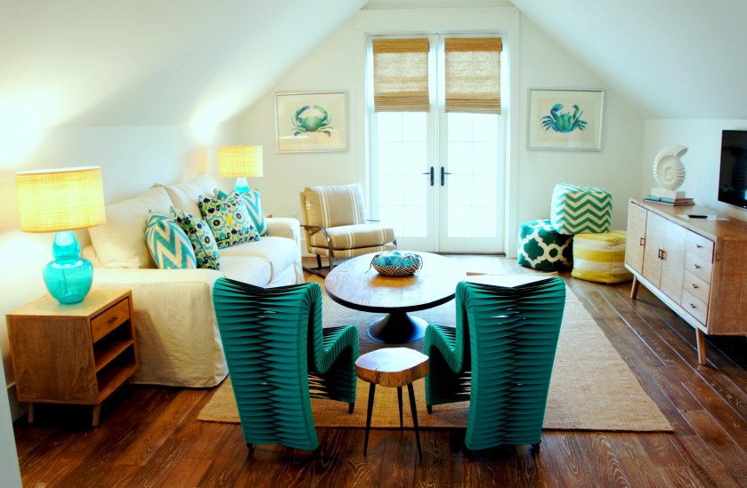 On the third floor, we have a loft that overlooks the pool and beach pines. In here you can watch t.v., play games around the oval reclaimed coffee table, and sit or play on the mismatched "poufs", currently stacked in the corner. Stealing the show, are these two blue seatbelt chairs! In addition to being sculptural, unique and colorful, they are also surprisingly comfortable!