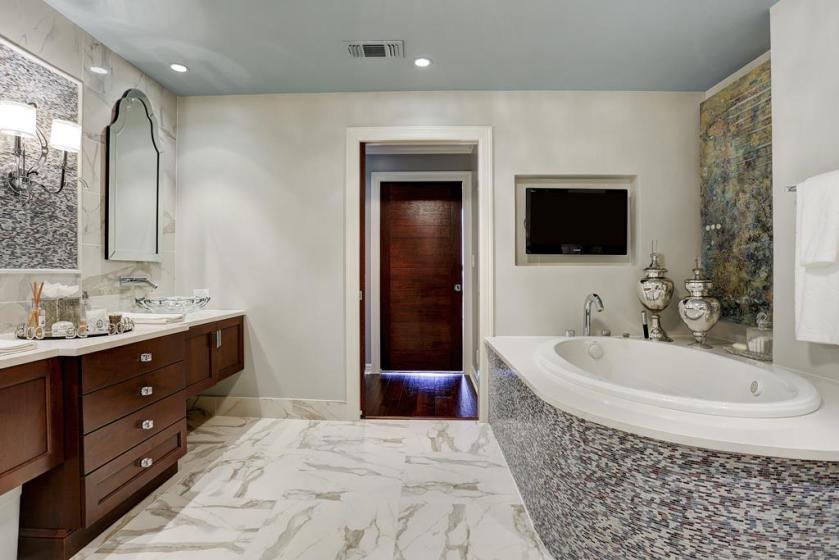 Master Bath After: We created a beautiful, open and functional double vanity, with ample lighting. We also added a brand new oval tub, with curved tub deck.