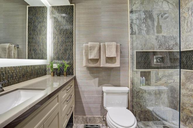 HIS Bathroom AFTER:  Whoa, what a difference, right??  Clean lines, masculine, bright, functional.  The electric mirror provided beautiful bright ligh, which reflected off of the glass tiles on the backsplash.  textured grasscloth stand up to the warm colors and finishes in this bath.  